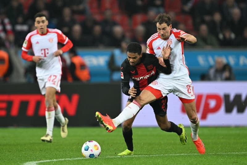 Bayern Munich's Leon Goretzka and Leverkusen's Amine Adli (l) battle for the ball during the German Bundesliga soccer match between Bayer Leverkusen and Bayern Munich at BayArena. Federico Gambarini/dpa