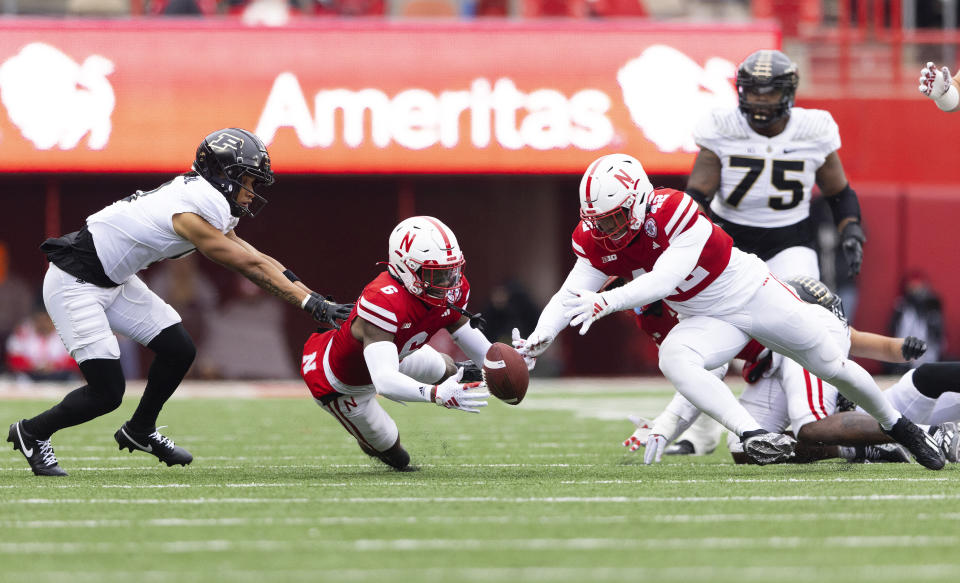 Nebraska's Quinton Newsome, center, and Mikai Gbayor, front right, recover a Purdue fumble against Purdue's Jayden Dixon-Veal, left, during the first half of an NCAA college football game Saturday, Oct. 28, 2023, in Lincoln, Neb. (AP Photo/Rebecca S. Gratz)