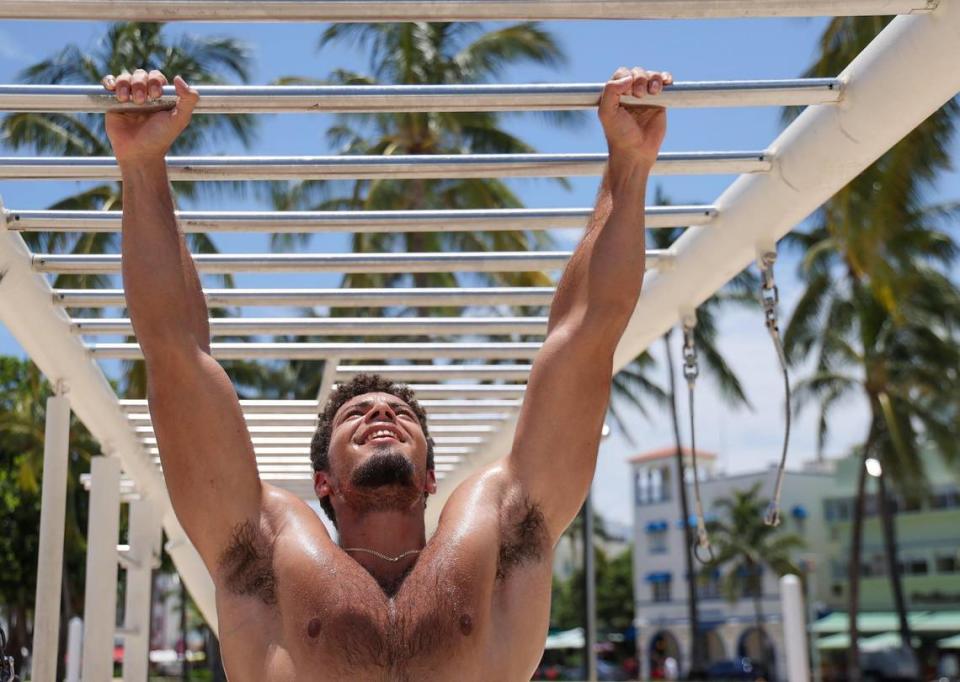Jose Villalon exercises at the My Equilibra, a wellness park underneath the high noon sun as the temperature reached above 90 degrees on Miami Beach, Florida