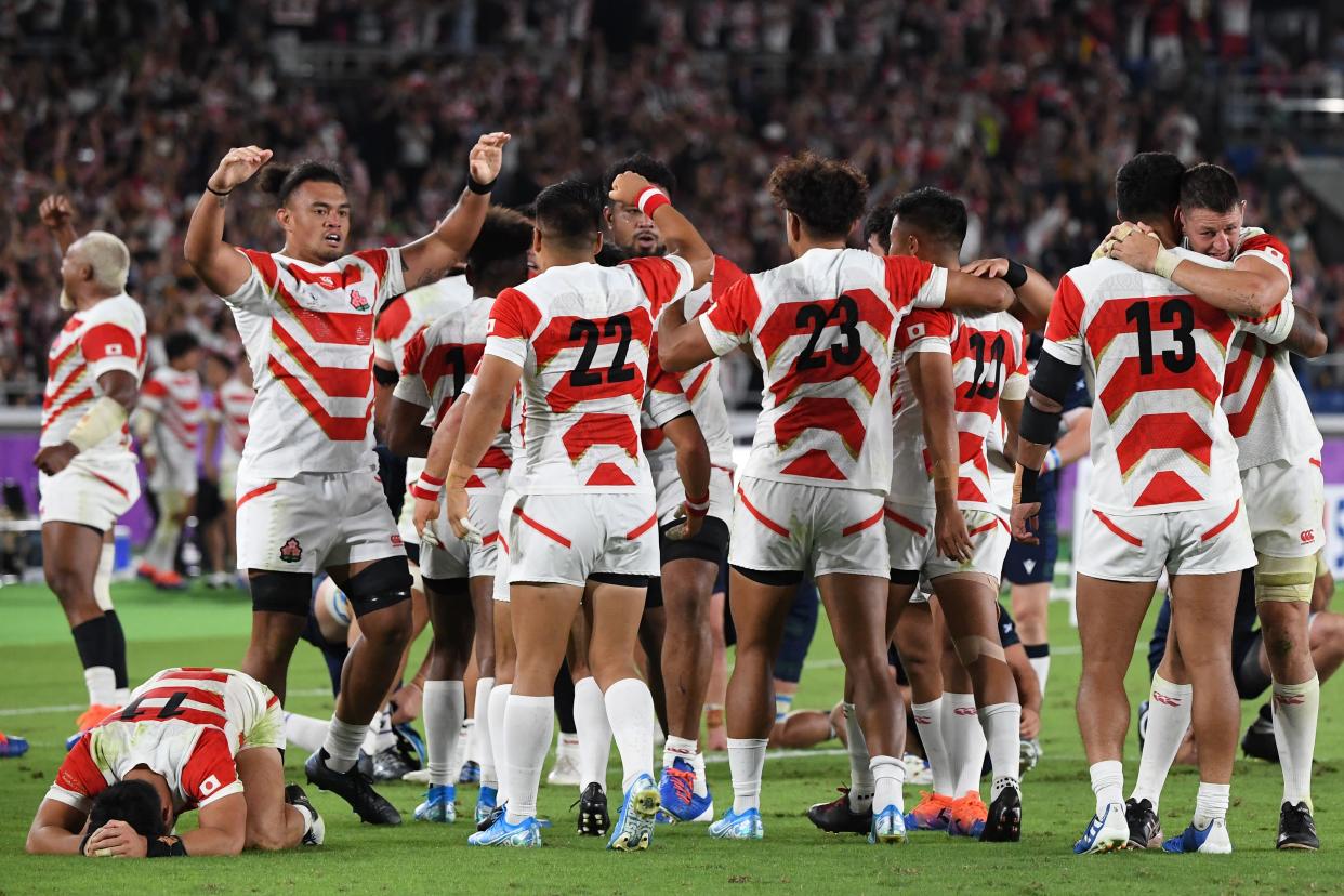 Japan celebrate their historic win9. (Photo by William WEST / AFP) (Photo by WILLIAM WEST/AFP via Getty Images)