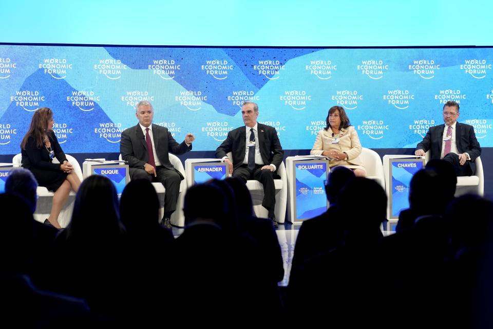 Marisol Argueta de Barillas, from left, President of Colombia Ivan Duque, Luis Rodolfo Abinader Corona, Dina Ercilia Boluarte and Rodrigo Chaves Robles attend a panel at the World Economic Forum in Davos, Switzerland, Tuesday, May 24, 2022. The annual meeting of the World Economic Forum is taking place in Davos from May 22 until May 26, 2022. (AP Photo/Markus Schreiber)