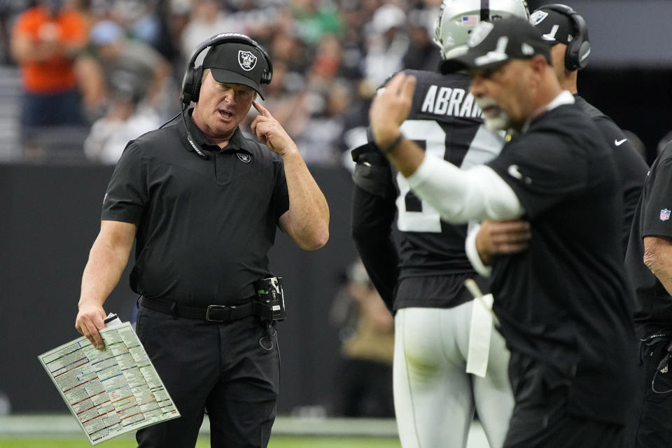 Las Vegas Raiders head coach Jon Gruden speaks on his headset during the first half of an NFL football game against the Chicago Bears, Sunday, Oct. 10, 2021, in Las Vegas. (AP Photo/Rick Scuteri)