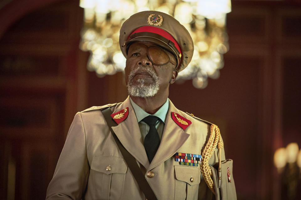 This image released by Netflix shows John Kani in a scene from the film "Murder Mystery 2." (Scott Yamano/Netflix via AP)