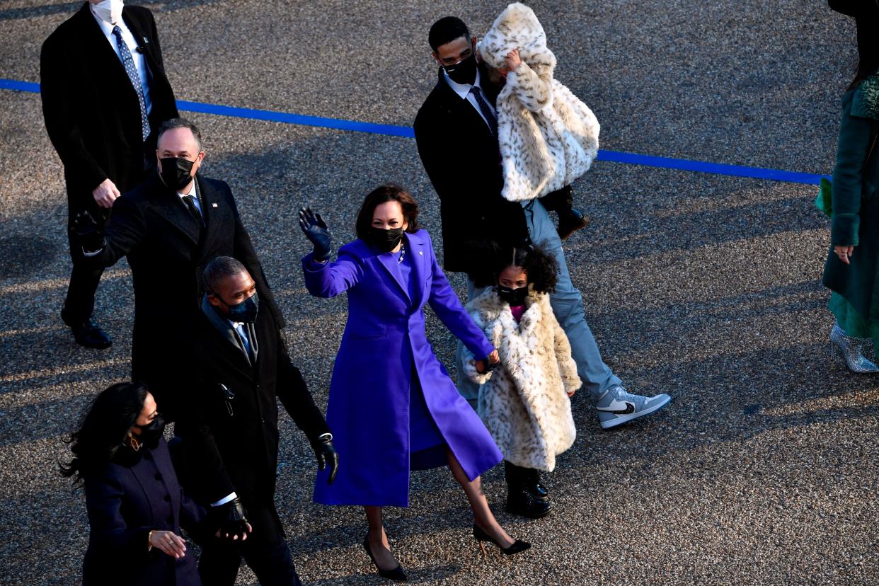 Vice President Kamala Harris walks with her family, including her niece's husband Nikolas Ajagu, during Wednesday's brief inaugural parade. (Photo: PATRICK T. FALLON via Getty Images)