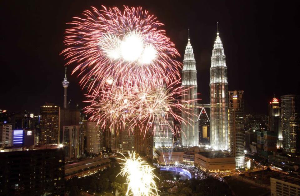 Fireworks explode near the Malaysia's landmark Petronas Twin Towers during New Year celebrations in Kuala Lumpur January 1, 2013.