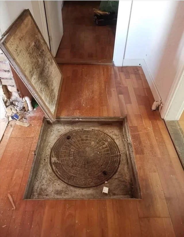 a manhole inside a hallway in someone's house