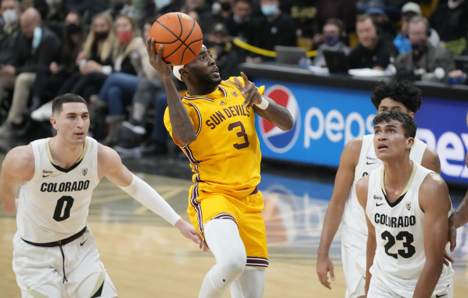 Arizona State guard Marreon Jackson, center, shoots from between Colorado guard Luke O'Brien, left, and forward Tristan da Silva during the first half of an NCAA college basketball game Thursday, Feb. 24, 2022, in Boulder, Colo. (AP Photo/David Zalubowski)