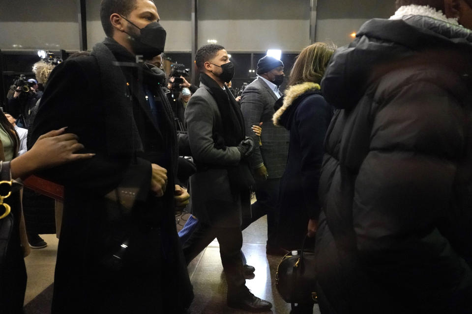 Actor Jussie Smollett, center, returns to the Leighton Criminal Courthouse, Thursday, Dec. 9, 2021, in Chicago. Smollett was convicted Thursday on five of six charges he staged an anti-gay, racist attack on himself nearly three years ago and then lied to Chicago police about it. (AP Photo/Nam Y. Huh)
