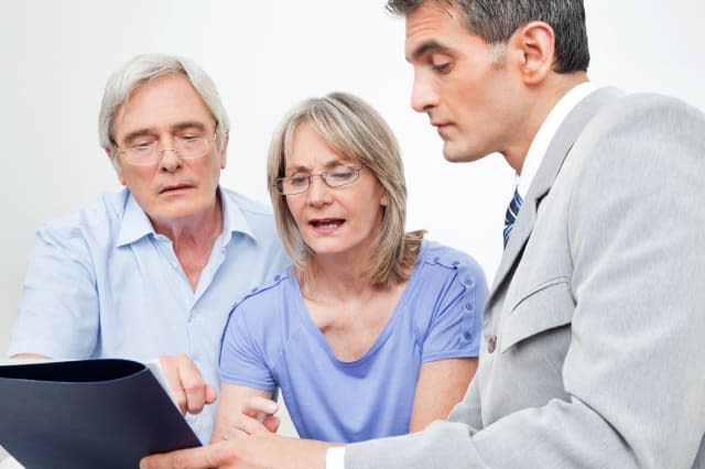 Senior couple getting financial advice from consultant at home