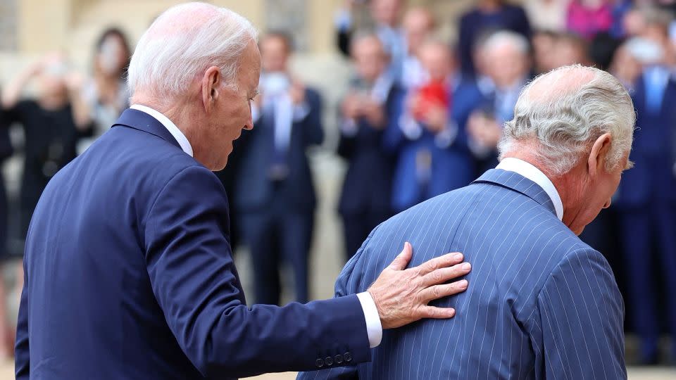 US President Joe Biden places his hand on the back of Britain's King Charles III as they walk in the Quadrangle after ceremonial welcome at Windsor Castle in Windsor on July 10, 2023. US President Joe Biden was in Britain on Monday, where he met with Prime Minister Rishi Sunak and King Charles III, before going on to a NATO summit in Lithuania. (Photo by Chris Jackson / POOL / AFP) (Photo by CHRIS JACKSON/POOL/AFP via Getty Images) - Chris Jackson/Pool/AFP/Getty Images
