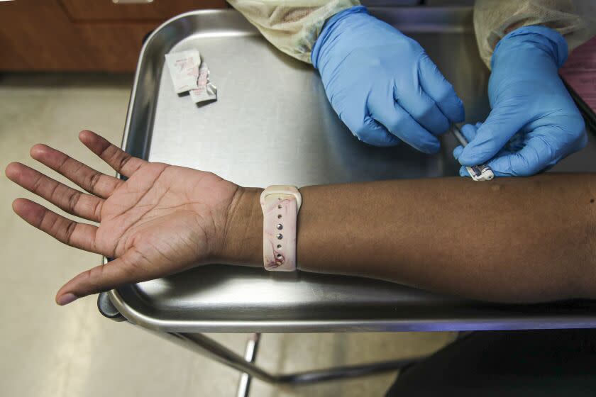 Los Angeles, CA - August 10: A recipient gets a Monkeypox virus vaccine at St.John's Well Child & Family Center on Wednesday, Aug. 10, 2022 in Los Angeles, CA. (Irfan Khan / Los Angeles Times)