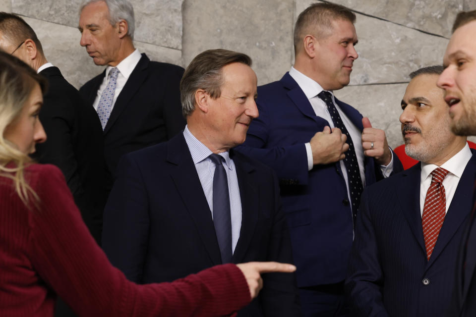 British Foreign Secretary David Cameron, center left, speaks with Turkey's Foreign Minister Hakan Fidan, center right, during a group photo of NATO foreign ministers at NATO headquarters in Brussels, Tuesday, Nov. 28, 2023. NATO foreign ministers on Tuesday begin a two-day meeting in which the alliance will reaffirm its support for Ukraine's defense against Russia's invasion, explore ways of easing tensions between Kosovo and Serbia and look at preparations for NATO's 75th anniversary next year. (AP Photo/Geert Vanden Wijngaert)