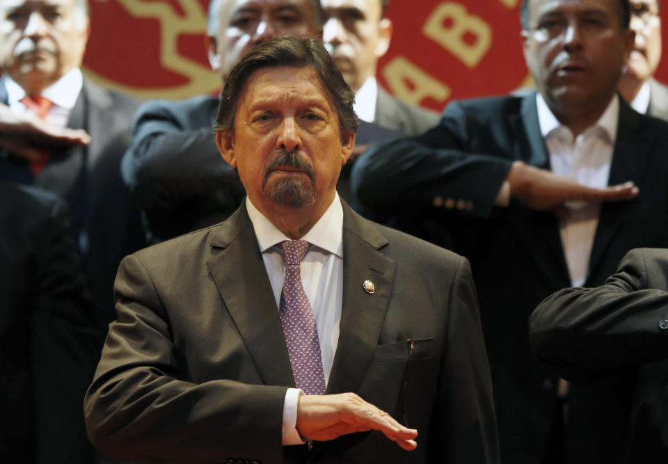 Miners' Union leader Napoleon Gomez Urrutia, who is also serves as a senator, salutes during the playing of the Mexican national anthem during the inauguration ceremony for his new International Labor Confederation (CIT) in Mexico City, Wednesday, Feb. 13, 2019. Urrutia says that 150 unions have joined the CIT and that other unions have expressed interest in joining, the latest sign that Mexico's long-dormant labor movement is awakening, and one month after massive walkouts began at border assembly plants in Matamoros. (AP Photo/Marco Ugarte)