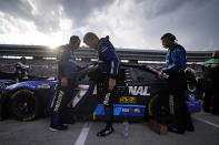 With clouds threatening lightning, Chris Buescher gets out of his car as a NASCAR Cup Series auto race field sits under a red flag delay at Texas Motor Speedway in Fort Worth, Texas, Sunday, Sept. 25, 2022. (AP Photo/LM Otero)
