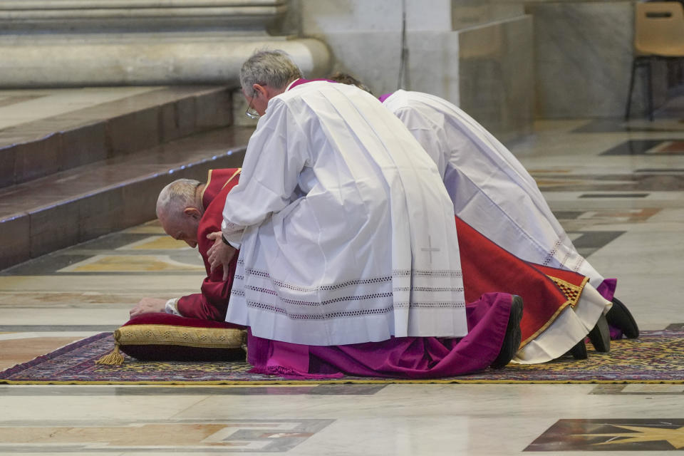 Pope Francis lies down in prayer prior to celebrate Mass for the Passion of Christ, at St. Peter's Basilica, at the Vatican, Friday, April 10, 2020. The new coronavirus causes mild or moderate symptoms for most people, but for some, especially older adults and people with existing health problems, it can cause more severe illness or death. (AP Photo/Andrew Medichini, Pool)