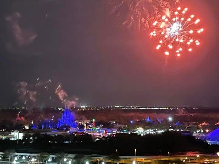 fireworks going off above disney world