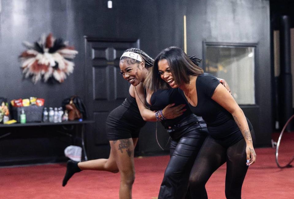 Amiah Nicks, left, owner of Millionaire Social, shares a hug Jan. 29, 2024, with her students as they nail down choreography at Millionaire Social in Charlotte.