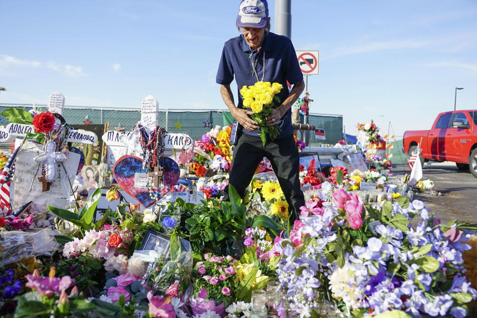 EL PASO, TX - AUGUST 16:  Antonio Basco, who's wife Margie Reckard was one of 22 persons killed by a gunman at a local Walmart, lays flowers in her honor at a makeshift memorial near the scene on August 16, 2019 in El Paso, Texas. Basco has been to the memorial everyday site since it was erected to clean up the area and put out fresh flowers. 22 people were killed in Walmart during a mass shooting on August 3rd. A 21-year-old white male suspect remains in custody in El Paso which sits along the U.S.-Mexico border. (Photo by Sandy Huffaker/Getty Images)
