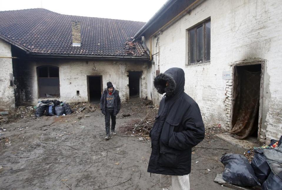 Migrants walk by an abandoned brick factory in the northern Serbian town of Subotica, near the border between Serbia and Hungary, Wednesday, Feb. 8, 2017. European Union countries have only taken in around 12,000 refugees from overburdened Greece and Italy despite promising to share 160,000 almost 18 months ago. (AP Photo/Darko Vojinovic)