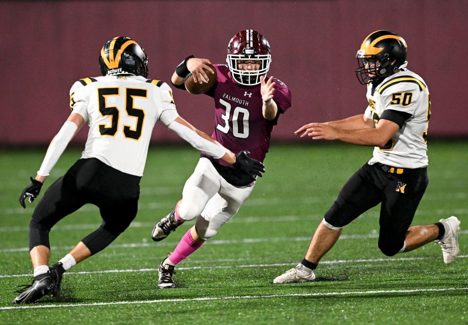 Collin Govoni of Falmouth attempts to break between Logan McWilliams (55) and Gabe Amaral of Nauset.