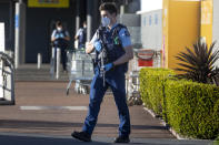 Armed police patrol outside a supermarket in Auckland, New Zealand, Saturday, Sept. 4, 2021. New Zealand authorities say they shot and killed a violent extremist, Friday Sept. 3, after he entered a supermarket and stabbed and injured six shoppers. Prime Minister Jacinda Ardern described Friday's incident as a terror attack. (AP Photo/Brett Phibbs)