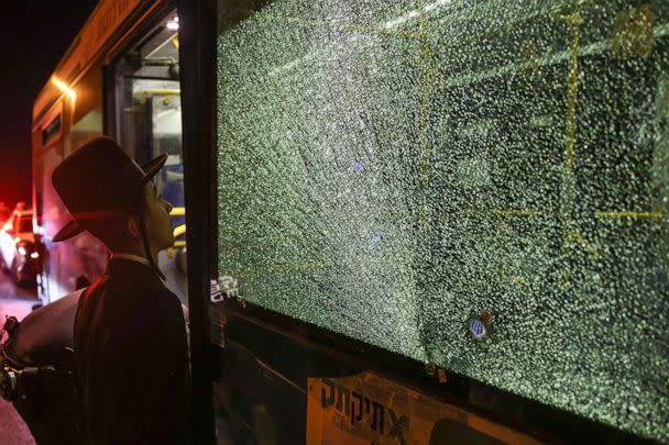 PHOTO: An ultra-Orthodox Jewish man looks at a bullet impact on a bus window after an attack outside Jerusalem's Old City, Aug. 14, 2022. (Ahmad Gharabli/AFP via Getty Images)