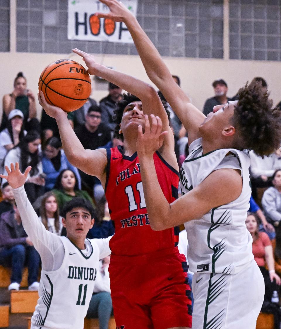 Tulare Western's Kaine Garcia shoots under pressure from Dinuba's Brice Watley in a West Yosemite League high school boys basketball game Thursday, January 12, 2023. 