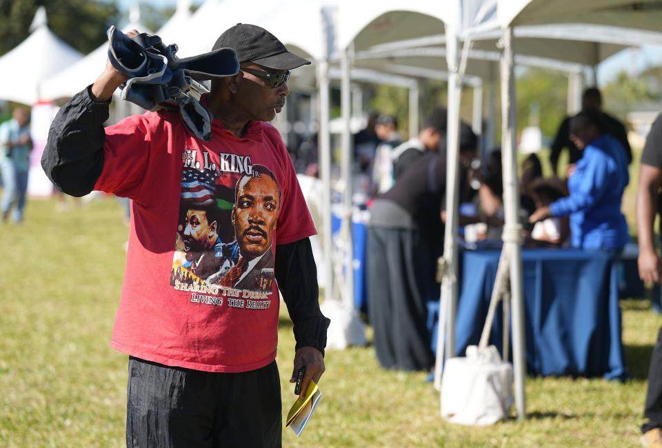 John Hepburn looks over the display tents during The City of Boynton Beach celebration in honor of Reverend Dr. Martin Luther King, Jr. on Monday, January 16th at Sara Sims Park.