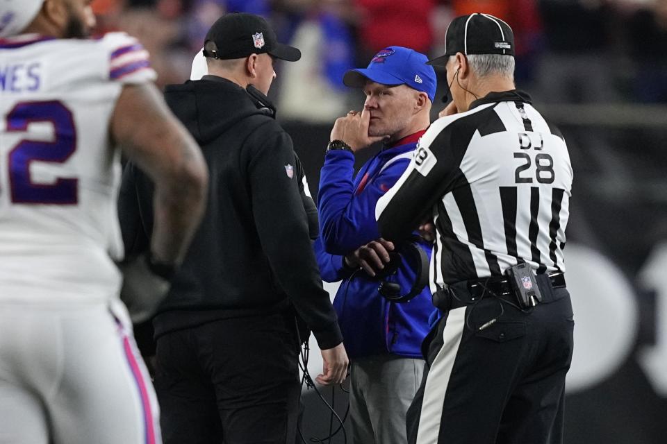 Bills coach Sean McDermott and Bengals coach Zac Taylor speak during the suspension of their game following the injury of Damar Hamlin on Monday.