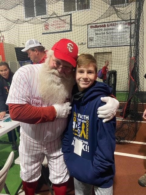 Jackson 11-year-old Alex Kacmarsky with 'Santa Jim' Mitchell.