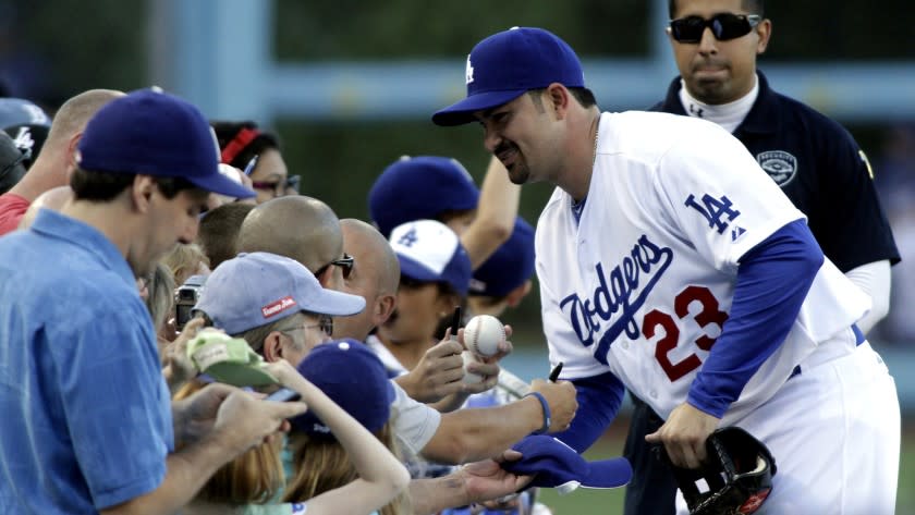 Dodgers first baseman Adrian Gonzalez signs autographs at Dodger Stadium.