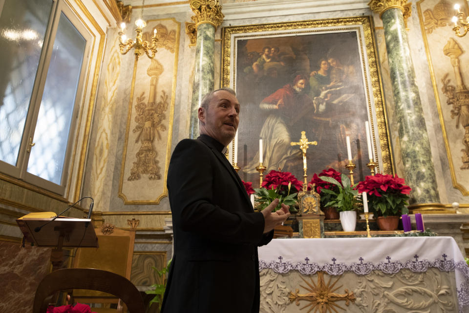 In this Monday, Dec. 9, 2019 photo, Monsignor John Kennedy, the head of the Congregation for the Doctrine of the Faith, walks through a chapel as he speaks during an interview at the Vatican. The Vatican office responsible for processing clergy sex abuse complaints has seen a record 1,000 cases reported from around the world this year, including from countries it had not heard from before, suggesting that the worst may be yet to come in a crisis that has plagued the Catholic Church. (AP Photo/Alessandra Tarantino)