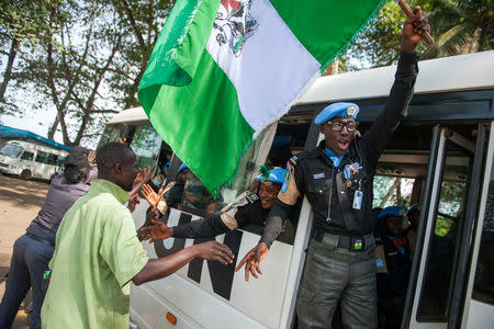 Members of the Formed Police Unit (FPU) from Nigeria deployed with UNMIL greet local people while traveling by bus to the airport in Harbel, Liberia March 16, 2018. Albert Gonzalez Farran/UNMIL/Handout via REUTERS