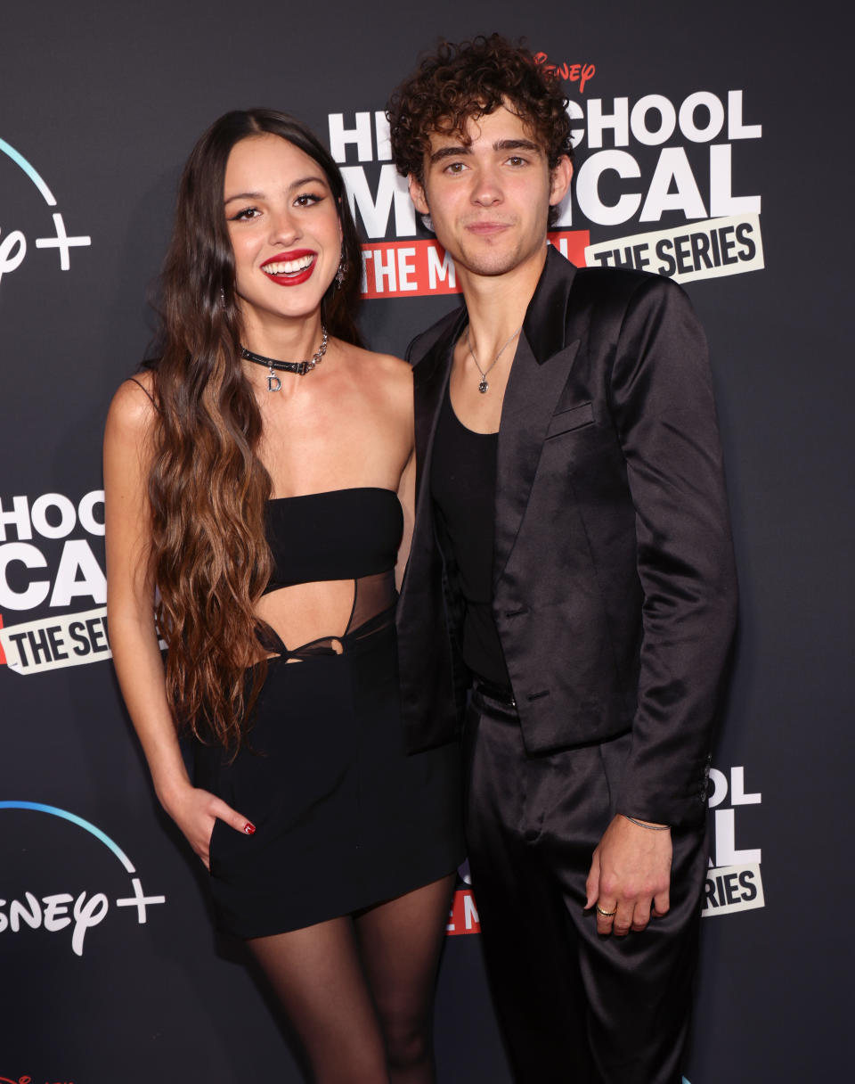 Olivia and Joshua smiling at a media event