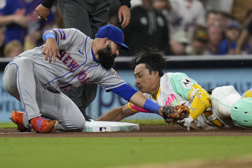 New York Mets third baseman Luis Guillorme, left, tags out San Diego Padres' Ha-Seong Kim, trying to reach third off a double during the seventh inning of a baseball game Friday, July 7, 2023, in San Diego. (AP Photo/Gregory Bull)