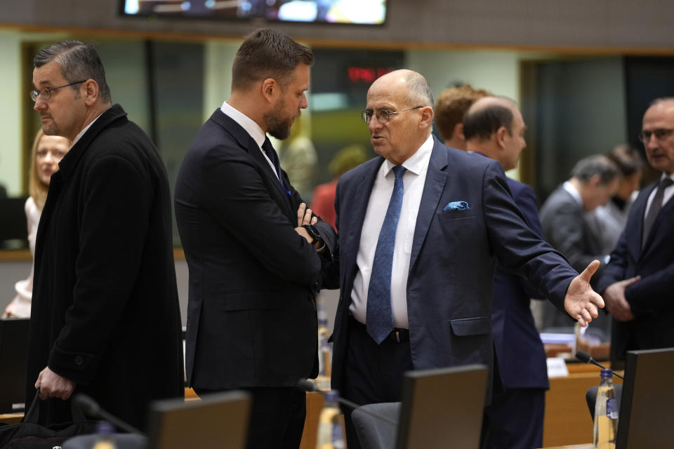 Poland's Foreign Minister Zbigniew Rau, right, speaks with Lithuania's Foreign Minister Gabrielius Landsbergis during a meeting of EU foreign ministers at the European Council building in Brussels on Monday, Jan. 23, 2023. EU foreign ministers are meeting to discuss support for Ukraine, including more money to help buy weapons, and the crackdown on demonstrators in Iran. (AP Photo/Virginia Mayo)