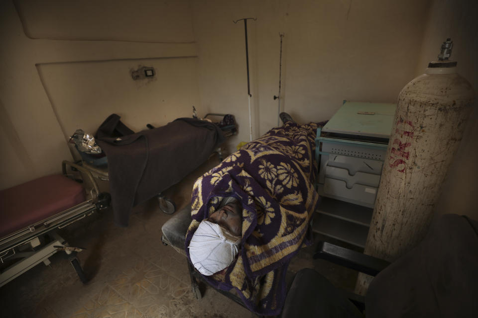 Bodies of a people killed in a shelling lay in hospital in Atareb, a town in rural western Aleppo, Syria, Sunday, March 22, 2021. Artillery shells fired from government areas killed at least five civilians and wounded medical staff when they landad in front of the hospital. (AP Photo/Ghaith Alsayed)