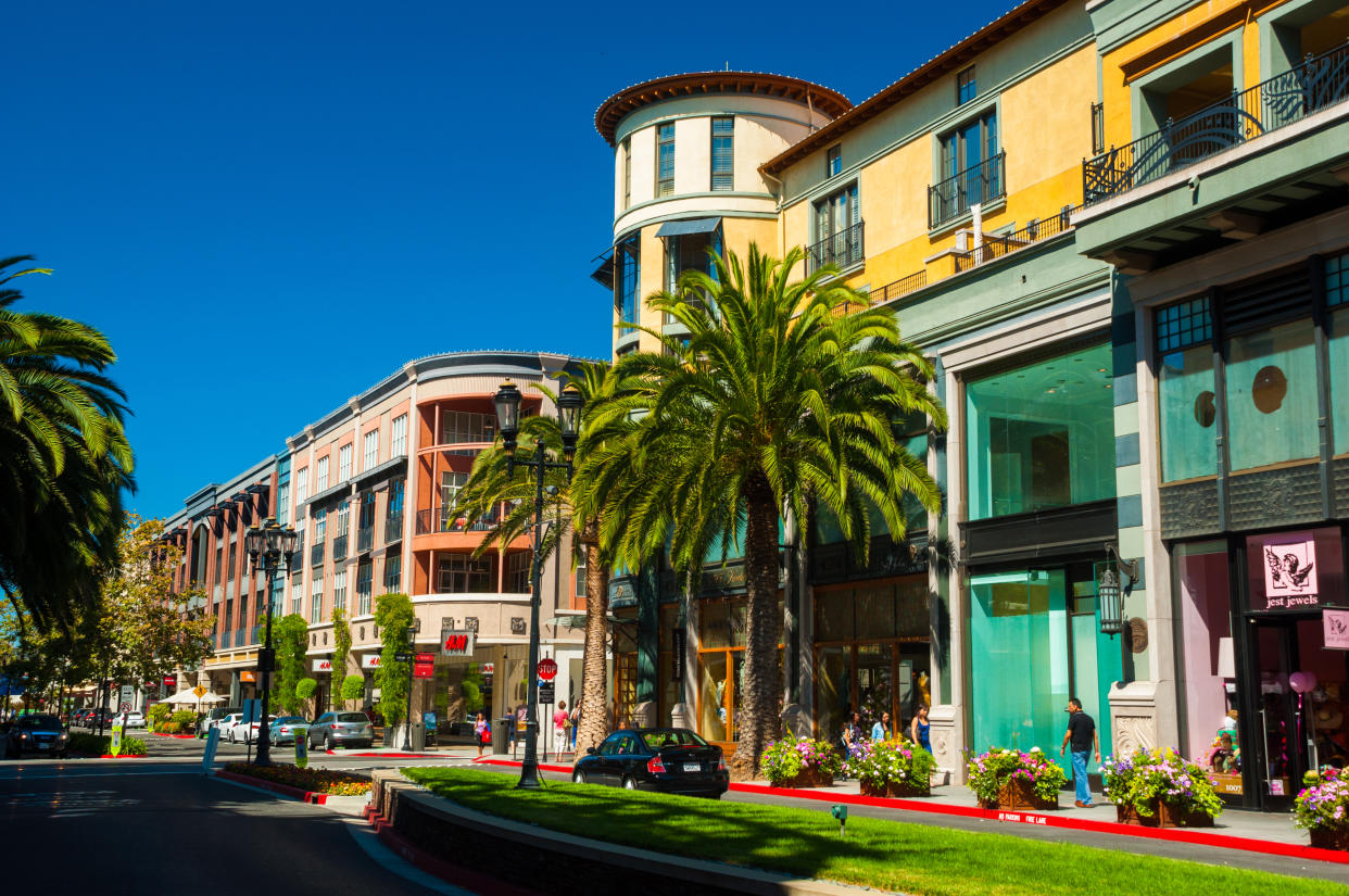 Shoppers stroll through mixed-use European style buildings of the upscale Santana Row shopping district in San Jose, California.