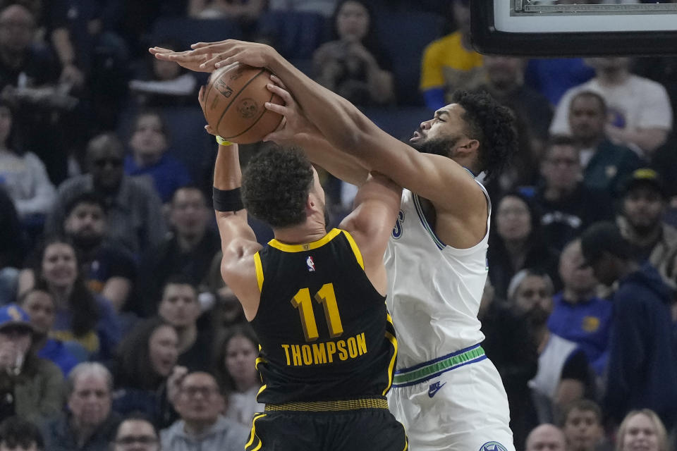 Minnesota Timberwolves center Karl-Anthony Towns, right, blocks a shot by Golden State Warriors guard Klay Thompson (11) during the first half of an NBA basketball game in San Francisco, Sunday, Nov. 12, 2023. (AP Photo/Jeff Chiu)