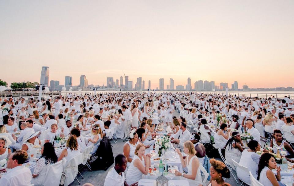 Dîner en Blanc is a dinner where the guests wear all white. Pictured is the Dîner en Blanc in New York in 2017.