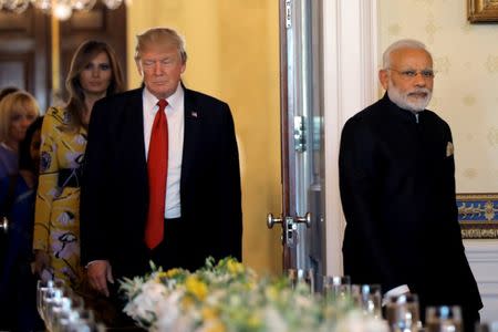 President Donald Trump and first lady Melania Trump welcome Indian Prime Minister Narendra Modi for a dinner at the White House in Washington. REUTERS/Carlos Barria