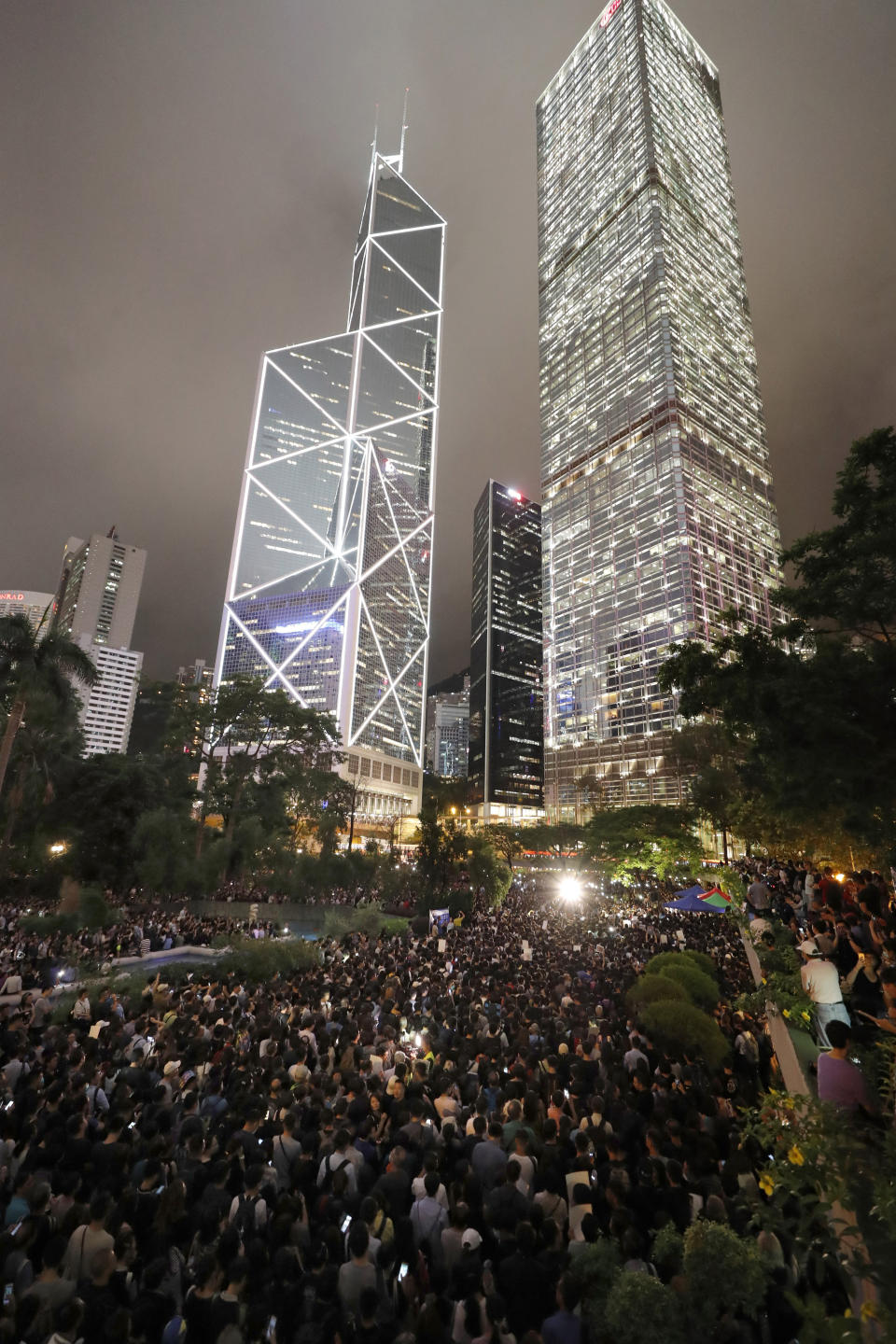 Protesters gather at a demonstration by civil servants in Hong Kong Friday, Aug. 2, 2019. Protesters plan to return to the streets again this weekend, angered by the government's refusal to answer their demands, violent tactics used by police - possibly in coordination with organized crime figures. (AP Photo/Vincent Thian)