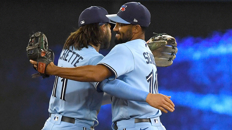 Blue Jays shortstop Bo Bichette (11) and second baseman Marcus Semien (10) embrace as they celebrate a win over the New York Yankees at Rogers Centre. (Dan Hamilton-USA TODAY Sports)