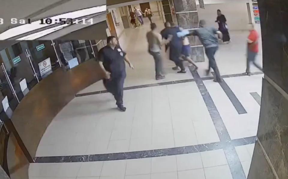 CCTV showing a hostage being taken into the hospital