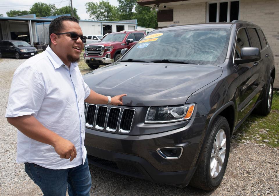 Antonio Estaba, the owner of Estaba Motors, shows off his inventory on Wednesday, May 31, 2023. Estaba, who specializes in selling vehicles to Hispanic customers, has seen his sales drop since the passage of Senate Bill 1718, which declares the state will no longer recognize driver's licenses from other states that are issued to people living in the country illegally.