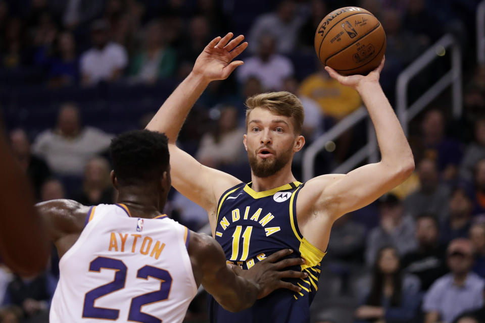 Indiana Pacers forward Domantas Sabonis (11) looks to pass over Phoenix Suns center Deandre Ayton (22) during the first half of an NBA basketball game, Wednesday, Jan. 22, 2020, in Phoenix. (AP Photo/Matt York)