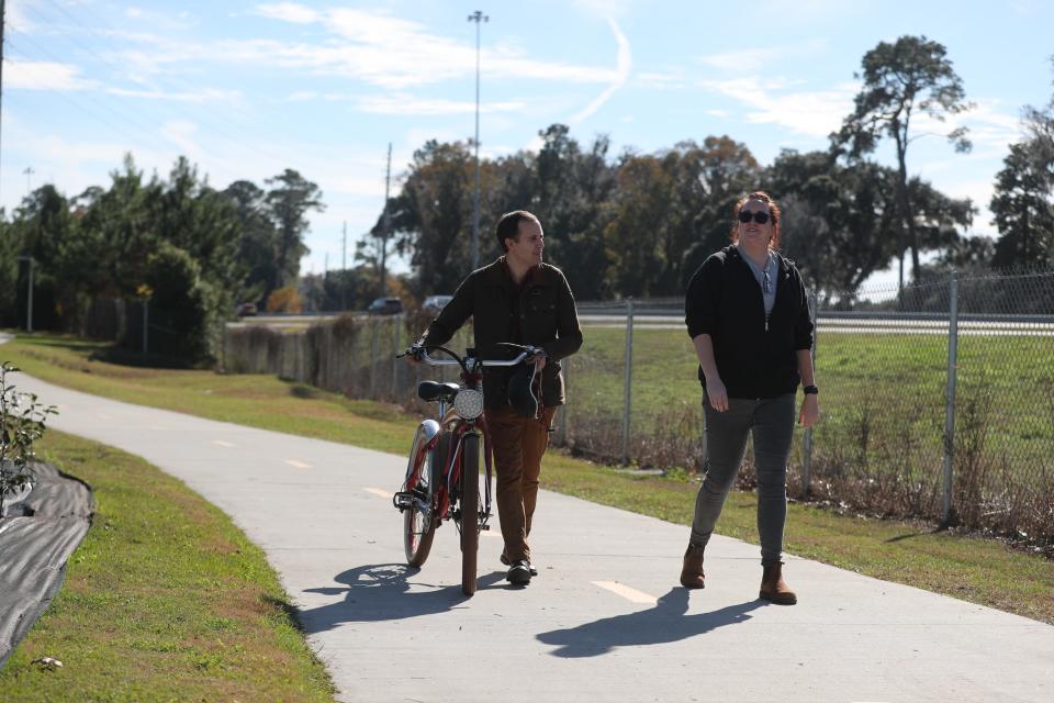 Savannah Alderman Nick Palumbo walks along the Truman Linear Trail with Caila Brown, executive director Bike Walk Savannah, on Tuesday December 5, 2023.