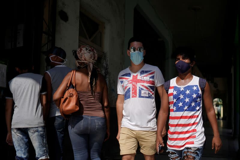 People wear T-shirts with Union Jack and a U.S. flag in downtown Havana