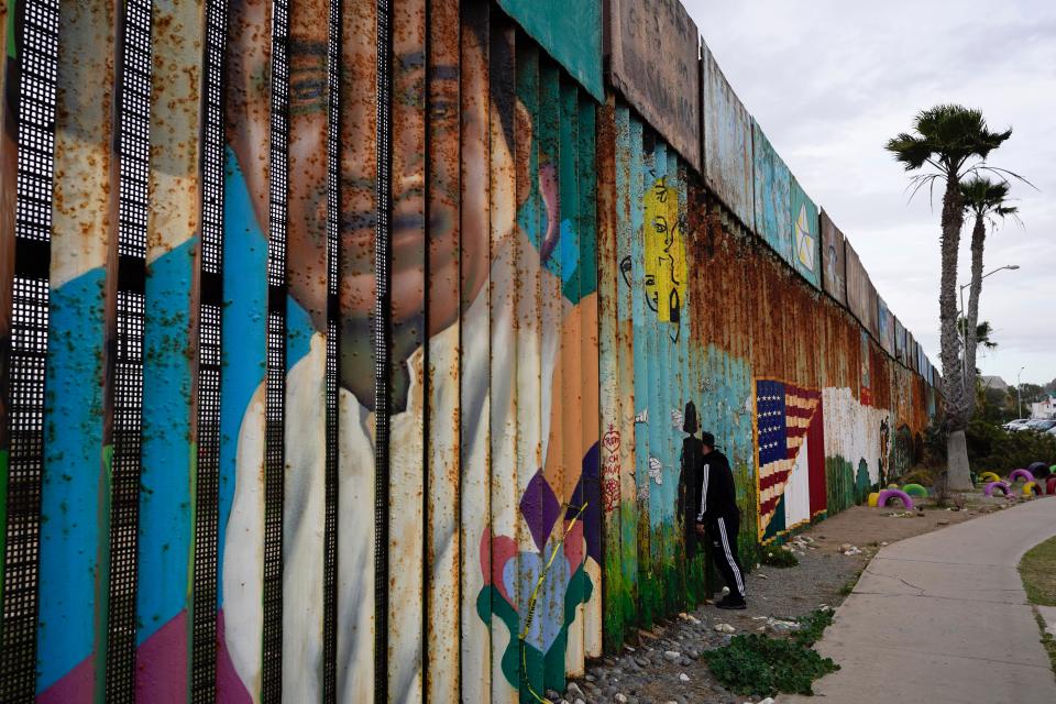 <p>A man looks through the first wall at Friendship Park, near where the border separating Tijuana, Mexico, and San Diego meets the Pacific Ocean Tuesday, Jan. 19, 2021, in Tijuana, Mexico.</p> (Associated Press)