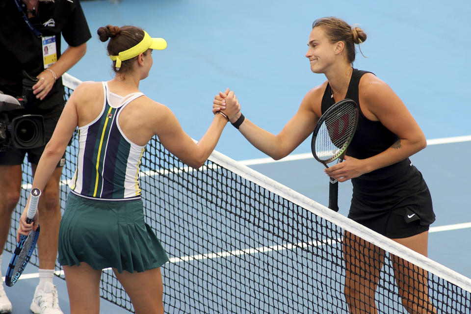 Belarus' Aryna Sabalenka, right, is celebrated at the net by Romania's Irina-Camelia Begu, after winning their semifinal match at the Adelaide International Tennis tournament in Adelaide, Australia, Saturday, Jan. 7, 2023. (AP Photo/Kelly Barnes)